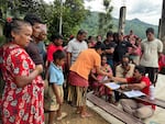 In this undated photo provided by Mercy Corps, aid workers in the Nuwakot district provide support to victims in the week following Nepal’s devastating flash floods.