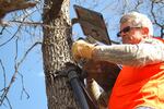 John McGowan sets up a camera at Oak Creek Wildlife Area.