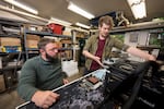 In this provided photo taken in June 2025, Oregon State University engineering professor Josh Gess (left) and faculty research associate Alec Nordlund (right) work on a system to cool servers by immersing them in dielectric oil.