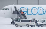 A detainee boards a deportation flight on GlobalX Air in Minnesota in December 2025.