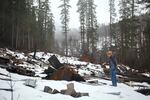 Jay Hennigan, president of the Breitenbush Cabin Owners Association, looks at some of the rubble remaining where his cabin once stood in Breitenbush, March 5, 2021. The cabin was destroyed by the Beachie Creek and Lionshead fires in 2020. 
