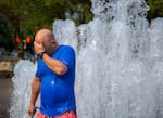 Jamie Test of Portland wipes the water from his face after cooling off in the fountain at Tom McCall Waterfront Park, Sept. 5, 2024. "The heat waves are getting real," said Test, who brought his family to the waterfront for relief from the heat. Excessive heat warnings will remain in effect on Friday.