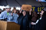 State Sen. Betsy Johnson, D-Astoria, holds up a wood cutting depcting the statehouse at a Timber Unity rally in front of the Oregon Capitol in Salem, Ore., Thursday, Feb. 6, 2020. Johnson opposes the cap-and -trade bill.