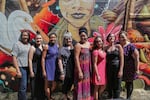 Members of the Black United Fund and Vox Siren pose in front of the mural.
