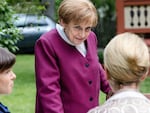 In a scene from the TV series, Miss Merkel, played by Katharina Thalbach, solves a murder case while her guests listen attentively.