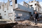 A block from the theater, Ashraf Jaradat stands outside his home, which he says was damaged in an Israeli military raid. He says he's left without an income since his shop was destroyed. "I'm a broken man," he says.