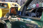 Many drivers park their cars on the side of the road to observe and enjoy the long parade of cars.