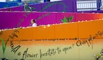 A woman pauses to read the inspirational messages included in the mural at the Hollywood Transit Center Sunday, May 27, 2018.