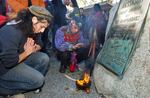 Supporters of Native Americans pause following a prayer during the 38th National Day of Mourning at Coles Hill in Plymouth, Mass., on Nov. 22, 2007.