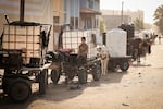 A boy in Khan Younis sits on donkey-drawn cart loaded with a water tank, as drinking water and fuel become increasingly scarce in Gaza.