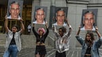 A protest group called "Hot Mess" holds up signs of Jeffrey Epstein on July 8, 2019 in New York City.