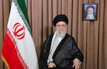 This photo released by an official website of the office of the Iranian supreme leader, shows Supreme Leader Ayatollah Ali Khamenei in a televised speech, under a portrait of the late revolutionary founder Ayatollah Khomeini, Friday, June 13, 2025. (Office of the Iranian Supreme Leader via AP)
