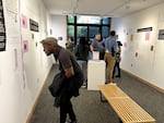 A crowd studies the exhibit “Sweeter Than the Onions: Stories of Queer Resilience in Walla Walla,” at Whitman College.