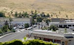 Cars line the quiet streets of Heppner, backgrounded by the dry, golden grasses of the high desert region