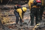 Firefighters' mop-up hotspots along the Ore Fire's edge against the control line to reduce heat along the fire line, as seen in this supplied photo, posted on July 26, 2024.