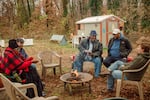 The "congregation" gathers on a Sunday morning in early November at the Battlefield Farm & Gardens in Knoxville, Tenn. Pastor Chris Battle, center, left the Baptist church and started the community garden and a free food delivery as a way to build community and "do church differently."