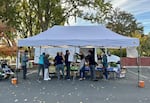 Shoppers line up at a Rogue Food Unites free farmers market in Talent on Oct. 26, 2023.