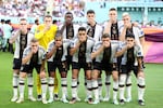 German players pose with their hands covering their mouths as they line up for the team photos prior to the FIFA World Cup Qatar 2022 match against Japan in Doha. The move was a rebuke against a clampdown on plans to wear rainbow armbands to protest discrimination in the host nation Qatar.