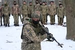 An instructor trains members of Ukraine's Territorial Defense Forces, volunteer military units of the Armed Forces, in a city park in Kyiv, Ukraine, Saturday, Jan. 22, 2022. Dozens of civilians have been joining Ukraine's army reserves in recent weeks amid fears about Russian invasion.