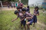 The students select specimens to examine under their foldscopes, in the field outside their classroom. Pandiarajan allows them to choose whatever they want as he believes the real way to learn science is through the natural world.