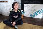 Henry Hunker, 11, sits in his living room in Southeast Portland on March 22, 2024. Hunker has a choking disorder called Dysphasgia, which requires trained professionals to help assist him whenever he eats at school.