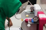 Jose Moreno, 14, waits for a 3-D printer to finish making parts for his LED-lit skateboard wheels at the Multnomah County Library's Rockwood branch.