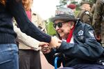 World War II veteran Jake Larson meets youths during ceremonies at the US cemetery to commemorate the 81st anniversary of the D-Day landings, on June 6, 2025 in Colleville-sur-Mer, Normandy.