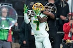 Oregon wide receiver Evan Stewart (7) pulls in a pass under the defense of Purdue defensive back Kyndrich Breedlove, center right, during the first half of an NCAA college football game in West Lafayette, Ind., Friday, Oct. 18, 2024. (AP Photo/AJ Mast)