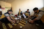 White Helmet members (from left to right) Qassem Masarawi, Ibrahim al-Rihani, Tarek Taleb and Mustafa Bakkar pour coffee for an Eid celebration inside the Kafr Sousa firehouse.