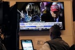 A screen on the floor of the New York Stock Exchange, Monday, Nov. 4, 2024 shows a broadcast talking about Kamala Harris and Donald Trump.