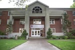 A student walks out of the Riley Center on the campus of Linfield College in McMinnville, Ore., Tuesday, May 21, 2019. Budget cuts and declining enrollment have forced tough decisions about the future of small, private colleges like Linfield.