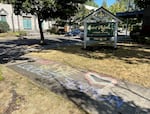 A rainbow chalk message that reads "let love be the loudest sermon" decorates the sidewalk in front of St. Agatha's Catholic School in Southeast Portland on Aug. 5, 2025. This was written after the school rescinded admission for a child who has same-sex parents.