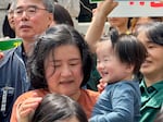 17-month-old Choi Heewoo nicknamed Woodpecker, held by his mother, is the youngest plaintiff in a landmark climate litigation case