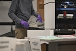 An election worker counts ballots inside the Maricopa County Tabulation and Election Center on Wednesday in Phoenix.