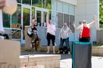 Some of the roughly 20 people protesting U.S. Immigration and Customs Enforcement in Portland stand outside their main office on Monday. 