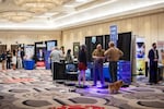 Attendees visit booths at the RePlatform conference in Las Vegas in March. The conference crowd was a hybrid of anti-vaccine activists, supporters of former President Donald Trump and Christian conservatives.