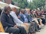 Portland Mayor Keith Wilson, fourth from left, sits among other local leaders at the celebration of the opening of the Albina One housing development in Northeast Portland on Saturday, Sept. 6. Acknowledging the past harms done to the area's Black community, Wilson said: “Our job today is to flip the script."