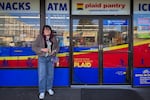 Simon Xu stands in front of a plaid store front