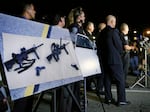 Police crime photos of assault rifles and handguns are displayed during a news conference near the site of a mass shooting in San Bernardino, Calif., on Dec. 3, 2015.