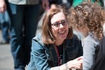 Oregon Gov. Kate Brown stops to thank a child named Clementine for coming out to support the LGBT community during the Portland Pride Parade Sunday, June 19, 2016.