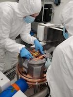 Researchers install the copper box containing the detector modules. Surrounding the box is shielding made of lead from ancient Rome — the team chose lead so old that any radioactive contaminants within it would have already decayed.