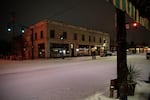 A couple takes a selfie on an empty street in the heart of the Hawthorne district in Portland. 