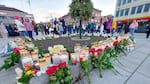 Flowers and candles are placed at a memorial after a man killed several people in Kongsberg, Norway.