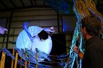 Michael Curry directs the lead actress playing Persephone in an aerial ballet scene. The character is played by both a puppet and a live actress. 