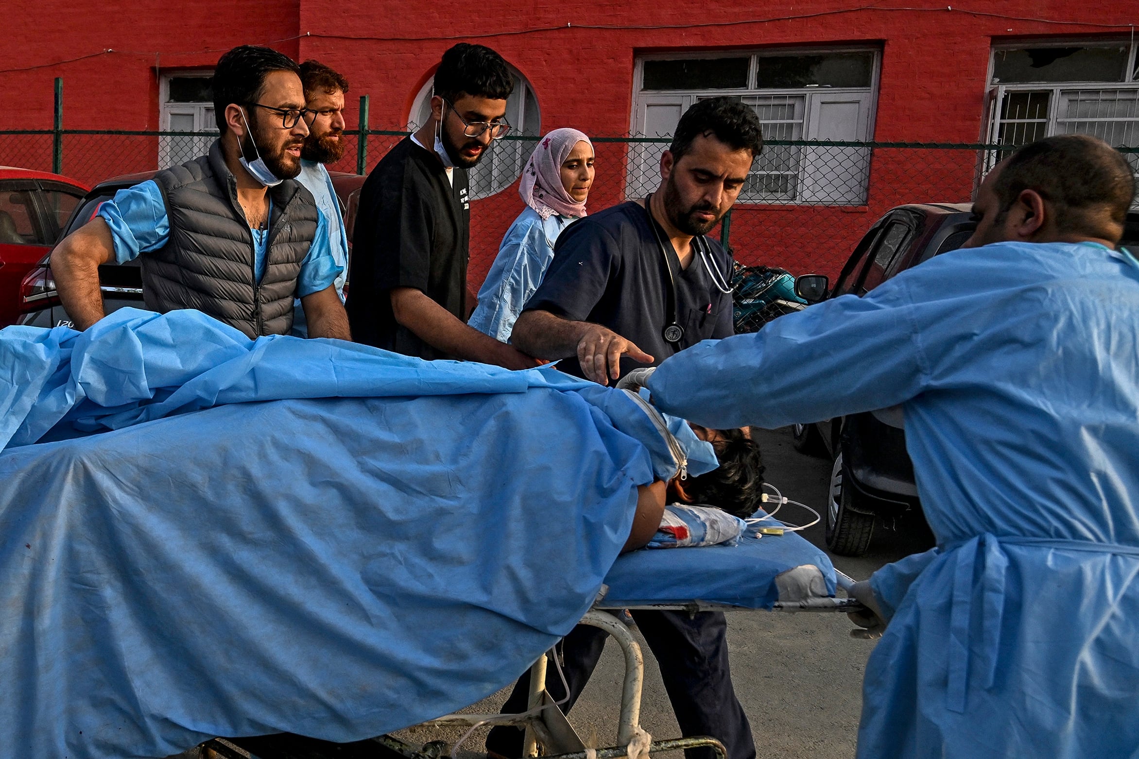 Paramedics carry an injured tourist at a hospital in Anantnag, south of Srinagar, on April 22, following an attack. Gunmen in Indian-administered Kashmir opened fire on a group of tourists in one of the worst attacks targeting civilians for years in the region.