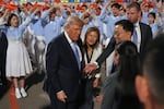 President Donald Trump talks during an arrival ceremony Wednesday, May 13, 2026, at Beijing Capital International Airport in Beijing, with Eric Trump, right.