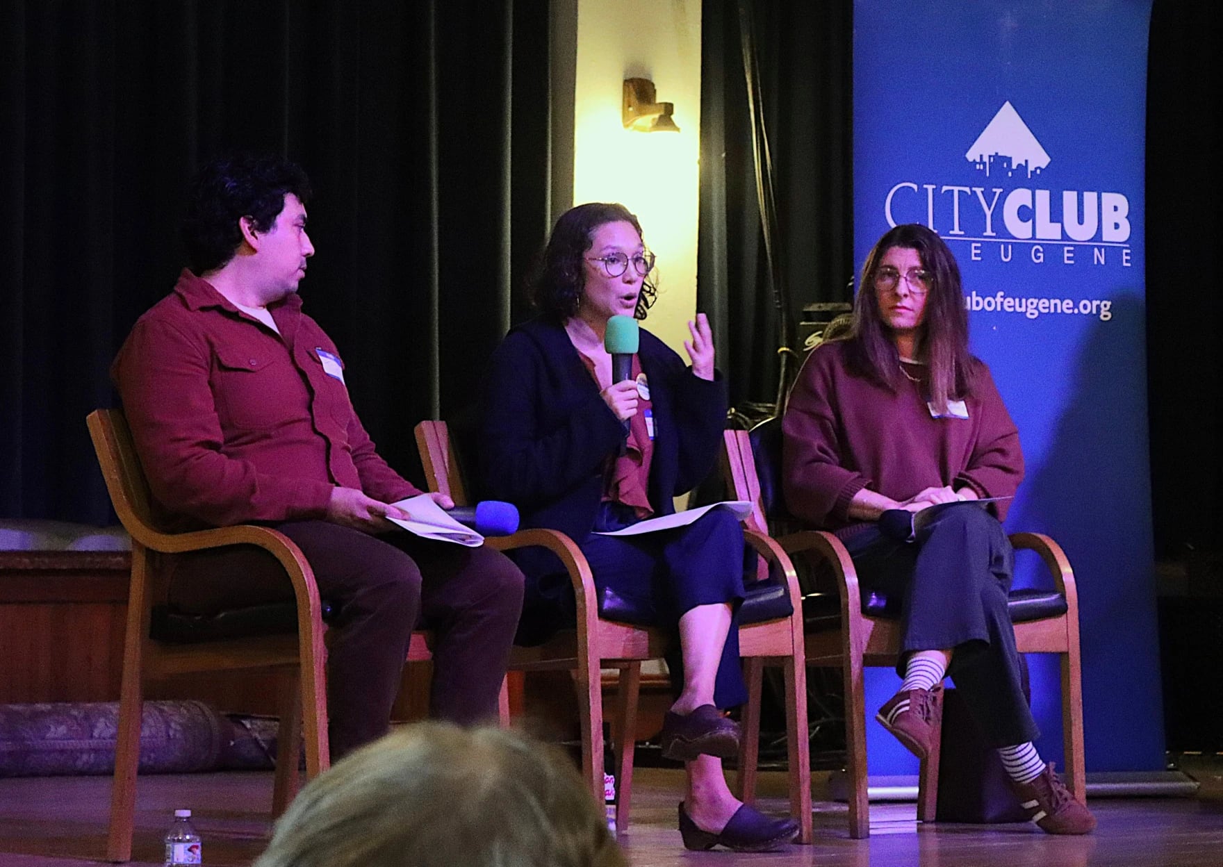Eugene Clean Energy Fund supporters Tim Herrera, left, and Aya Cockram, center, debate opposition campaign volunteer Laura Sedwick, right, at City Club of Eugene, Sept. 25, 2026.