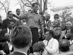 James Baldwin smiles while addressing the crowd from the speaker's platform, after participating in the march from Selma to Montgomery in support of voting rights, Alabama, March 1965.