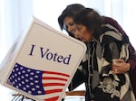 Republican presidential candidate former U.N. Ambassador Nikki Haley (L) helps her mother Raj Kaur Randhawa (R) cast her ballot in the South Carolina Republican primary on Saturday in Kiawah Island, S.C.