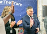 FILE - Sitton Elementary principal Becky Berry (left) and Portland Public Schools Superintendent Guadalupe Guerrero (right) applaud and high-five students walking the red carpet on their first day of school in Portland on August 29, 2023. Guerrero announced Thursday that he has landed a new leadership job at the Partnership for Los Angeles Schools.